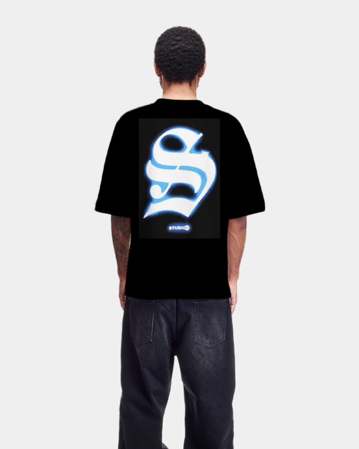 Person wearing a black t-shirt with a white logo on the back against a white background