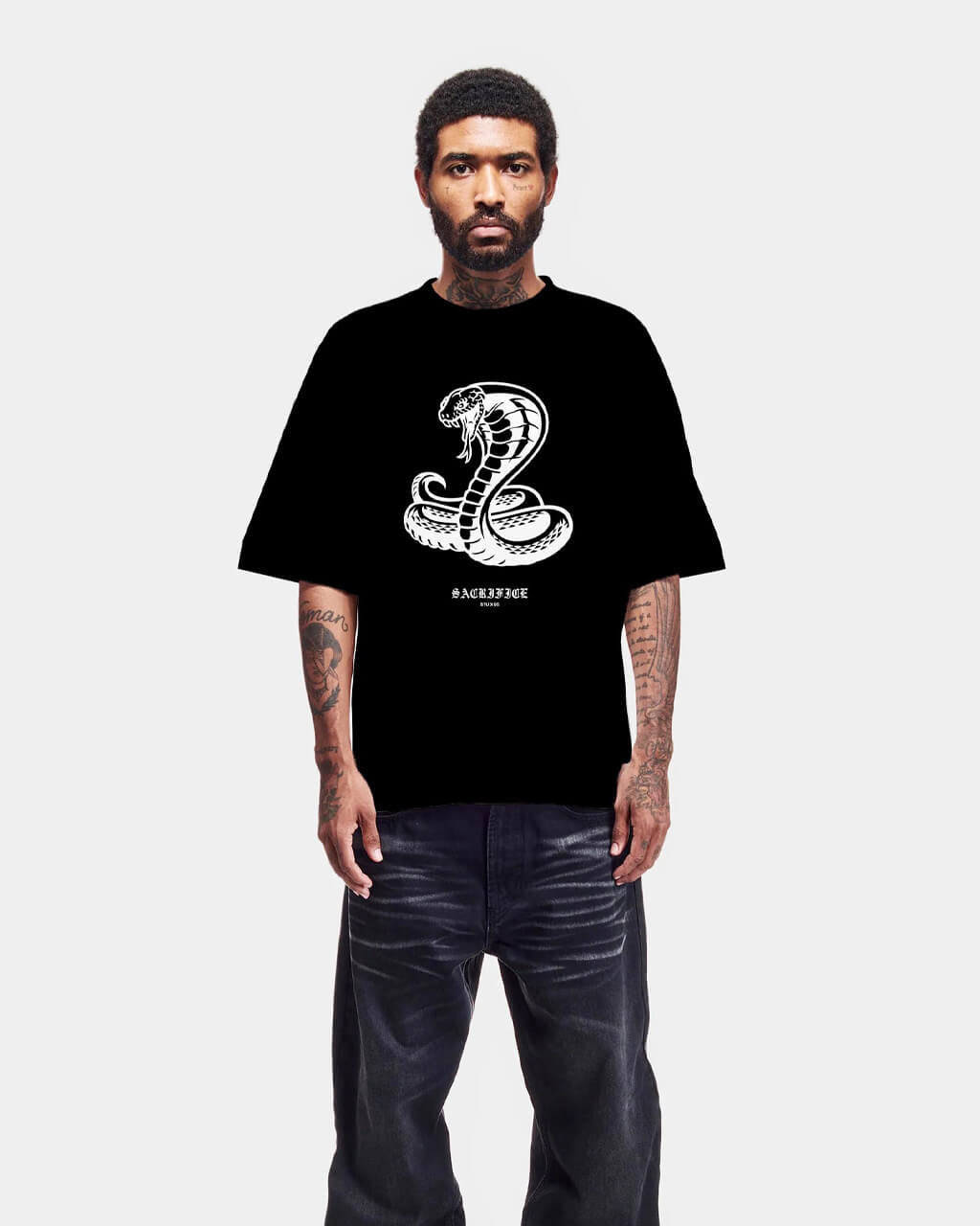 Person wearing a black t-shirt with a white logo on a white background