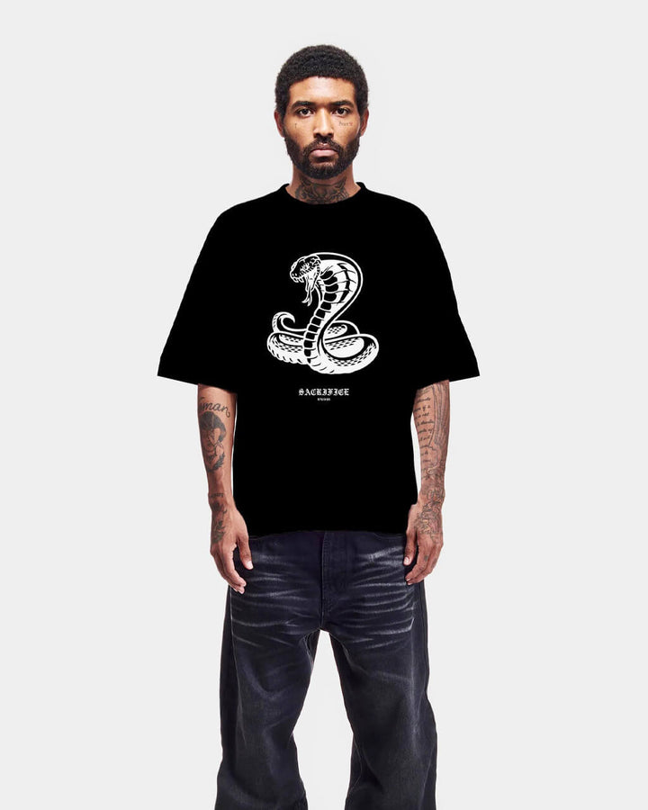Person wearing a black t-shirt with a white logo on a white background