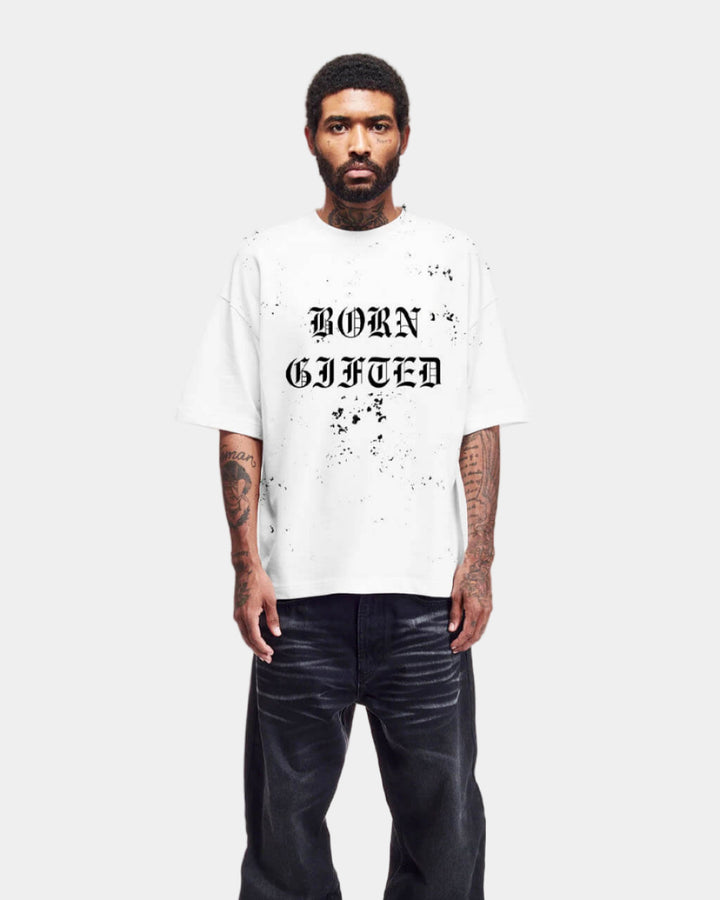 Person wearing a white t-shirt with 'BORN GIFTED' text on a plain background