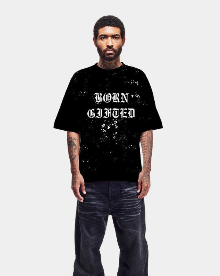 Person wearing a black t-shirt with 'BORN gifted' text on a white background