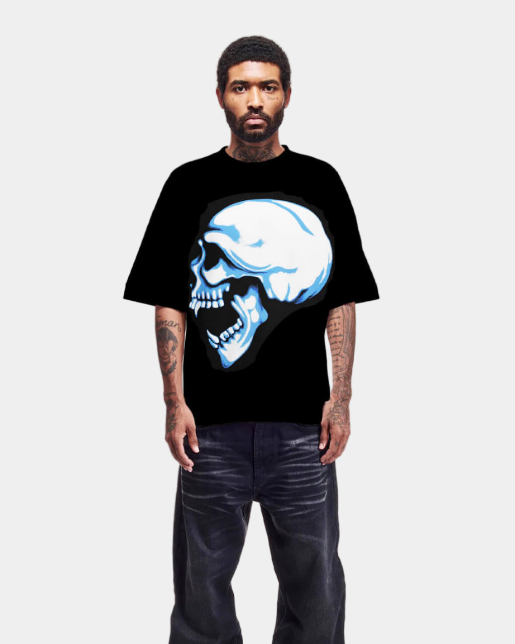 Person wearing a black t-shirt with a blue skull design on a white background