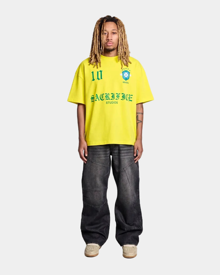 model wearing a Brazil yellow oversized t-shirt with text and graphics on a light grey background