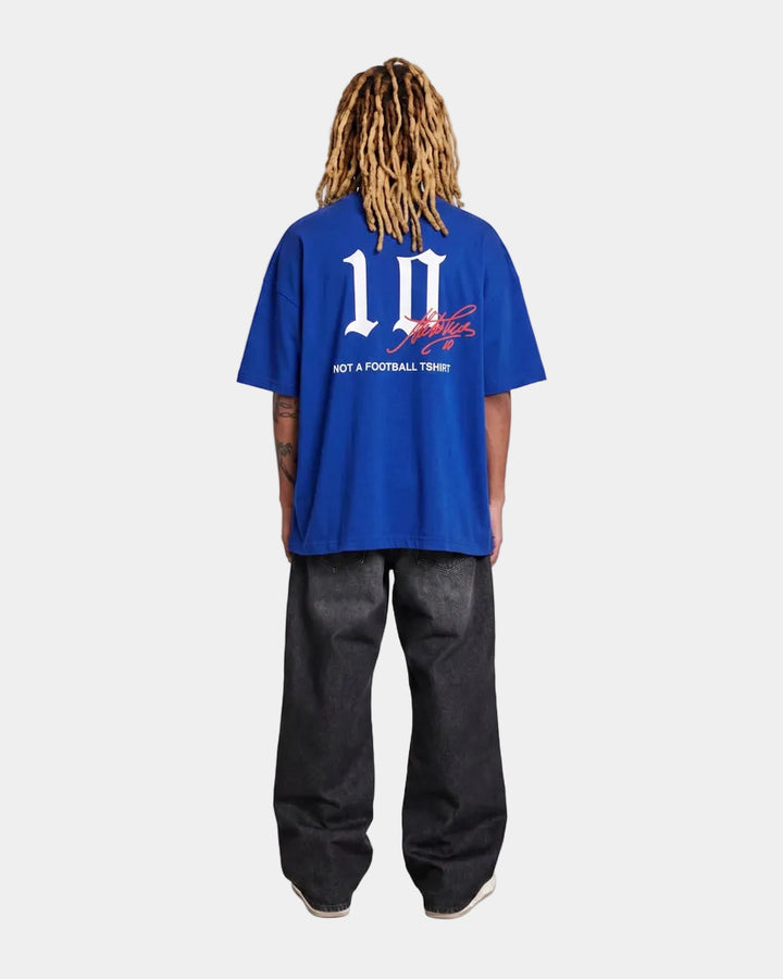 model wearing a italy blue oversized t-shirt with text and graphics on a light grey  background