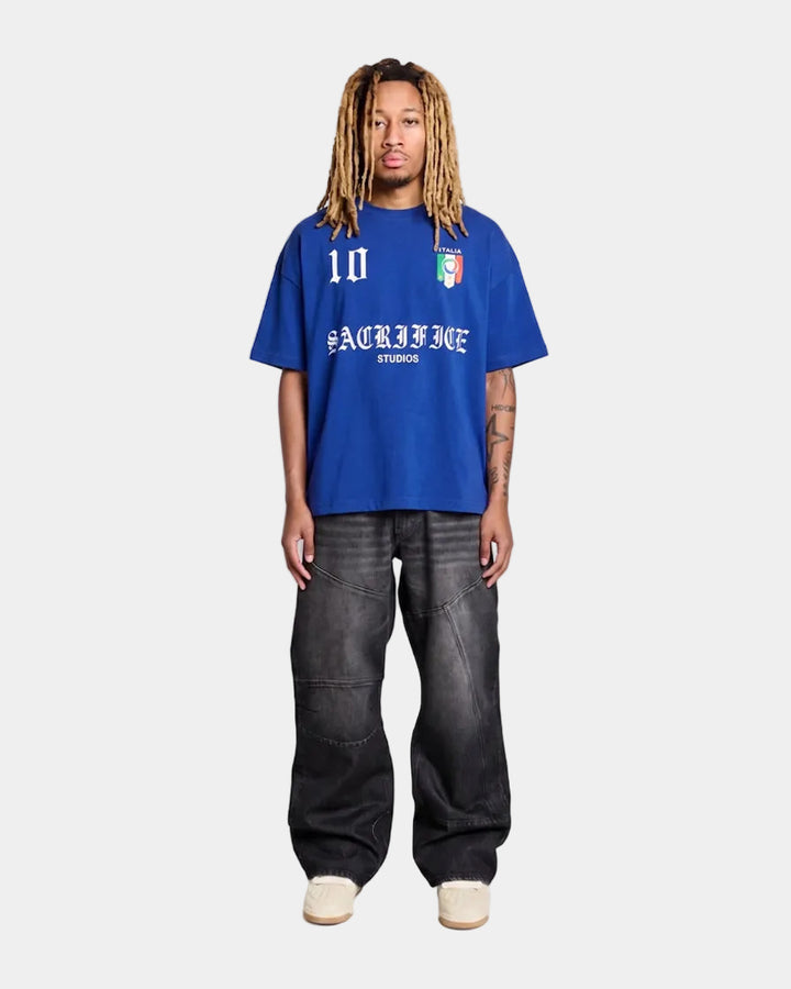 model wearing a italy blue oversized t-shirt with text and graphics on a light grey  background
